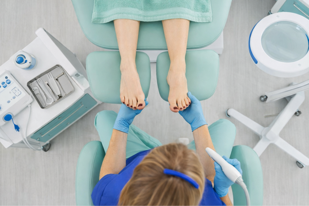 Podiatrist examining patient’s feet in clinic